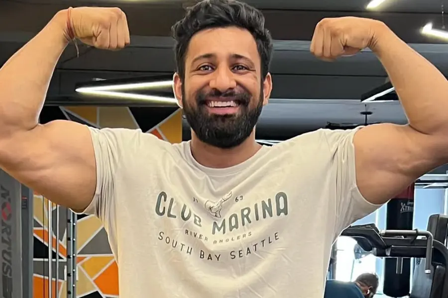 Rajat Dalal lifting heavy weights in gym showcasing strength and muscular physique.