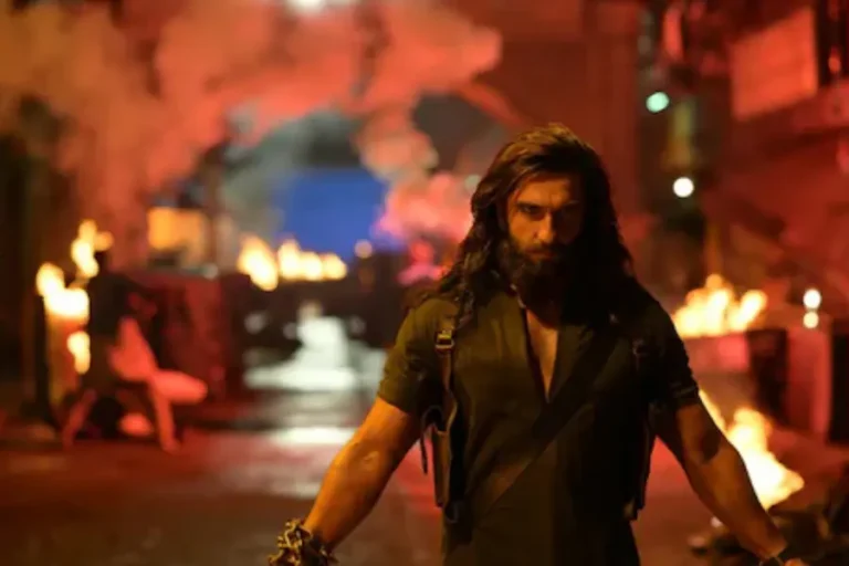 Ranveer Singh intense look in Dhurandhar 2 action scene with dramatic background and high-energy visuals.