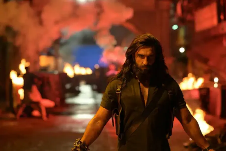 Ranveer Singh intense look in Dhurandhar 2 action scene with dramatic background and high-energy visuals.